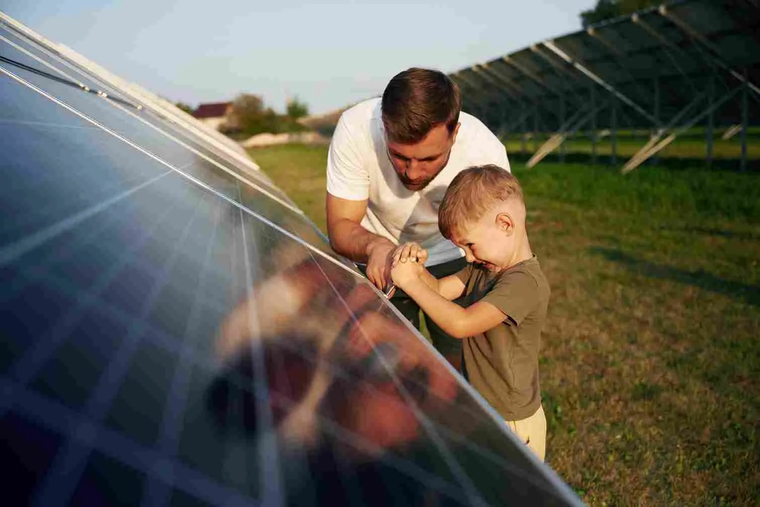 Family inspecting solar panels to understand the benefits of solar power.