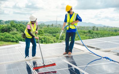 Do solar panels need cleaning Professional technician cleaning a rooftop solar panel for optimal efficiency