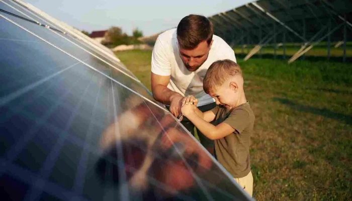 Family inspecting solar panels to understand the benefits of solar power.