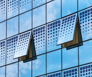 Modern solar windows installed on a commercial building generating renewable energy from sunlight.