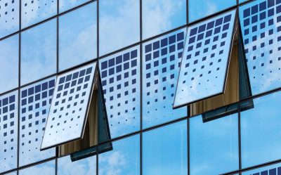 Modern solar windows installed on a commercial building generating renewable energy from sunlight.