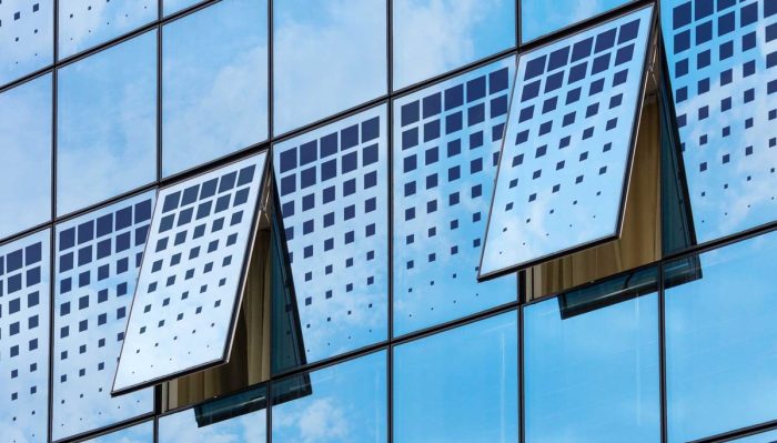 Modern solar windows installed on a commercial building generating renewable energy from sunlight.