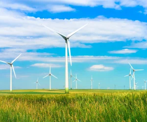 Modern wind turbines generating clean energy across a wide open field.